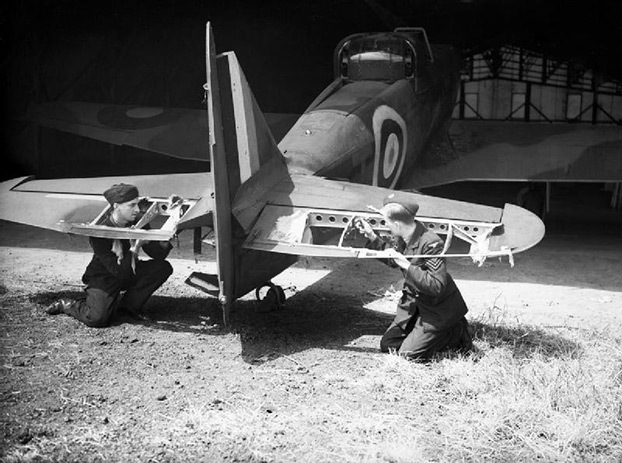Ground staff examine the damage to the elevators of a ...