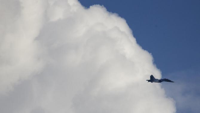 Russian Sukhoi jet flies during the Army-2015 show at a shooting range in Alabino, outside of Moscow, Russia, on Tuesday, June 16, 2015. Russia’s military this year alone will receive over 40 new intercontinental ballistic missiles capable of piercing any missile defences, President Vladimir Putin said Tuesday in a blunt reminder of the nation’s nuclear might amid tensions with the West over Ukraine. (AP Photo/Ivan Sekretarev)