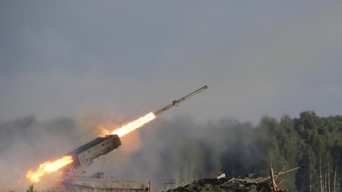 A Russian TOS-1A multiple rocket launcher fires during the opening of the Army-2015 international military forum in Kubinka